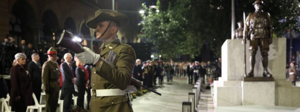 ANZAC Day dawn service Martin Place Sydney soldier standing at attention memorial crowd