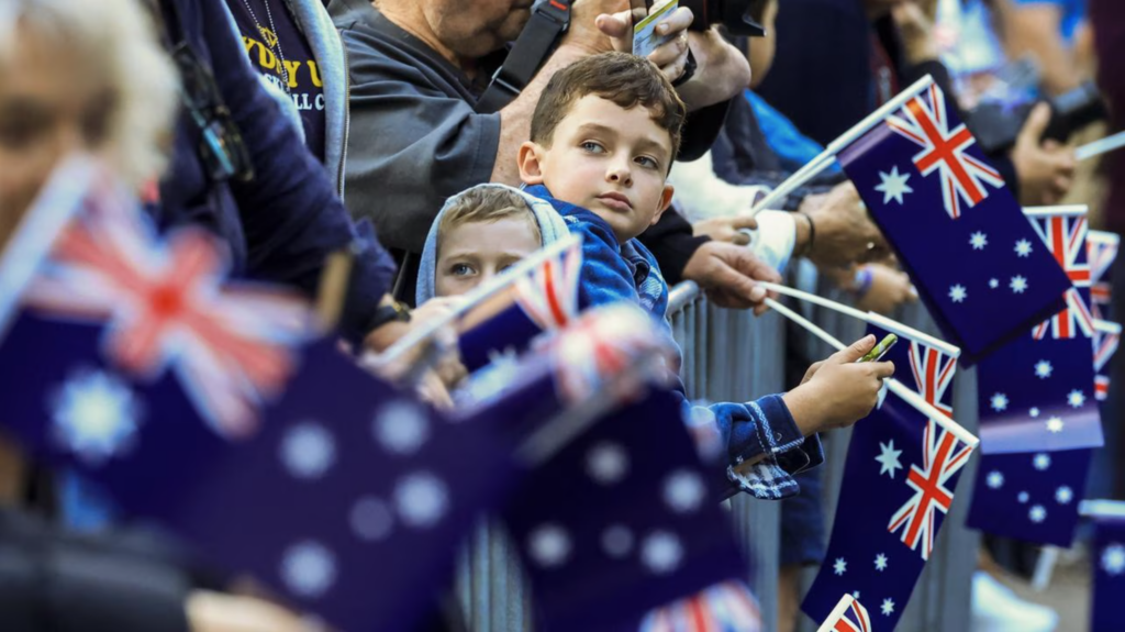 ANZAC Day Sydney crowd waving Australian flags during commemorative service